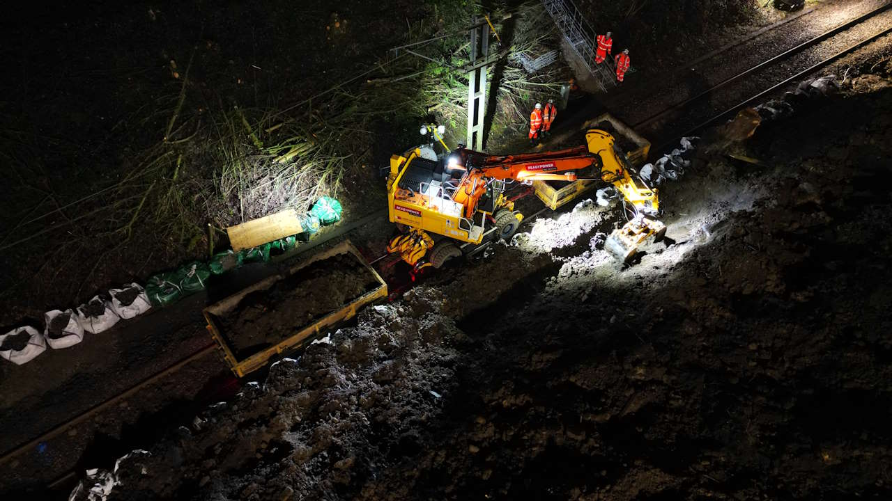 Specialist rail vehicles work to remove soil from landslip in Baildon