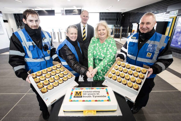  Nexus Customer Services Director and Metro customers service teams cutting the commemorative cake to celebrate Metro's 40th anniversary in South Tyneside with the Deputy Leader of South Tyneside Council Cllr Audrey Huntley.