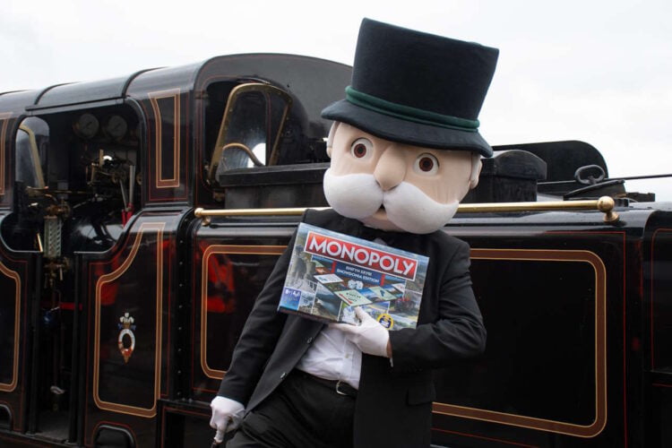 Mr Monopoly and the new MONOPOLY: Eryri / Snowdonia Edition, alongside James Spooner at Porthmadog Harbour Station. // Credit: Ffestiniog & Welsh Highland Railways 