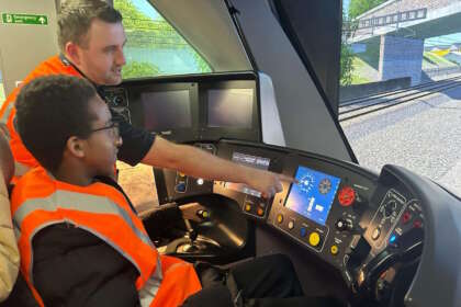 James Harrison, Senior Depot Manager at Alstom with a pupil from Ealing SEND Hub utilising the train simulator at Alstom’s Old Oak Common depot