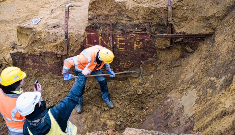 Archaeologists unearthing the LNER container wagon in a field Antwerp. Note the Wooden Body remains and the metal straps. - LNER