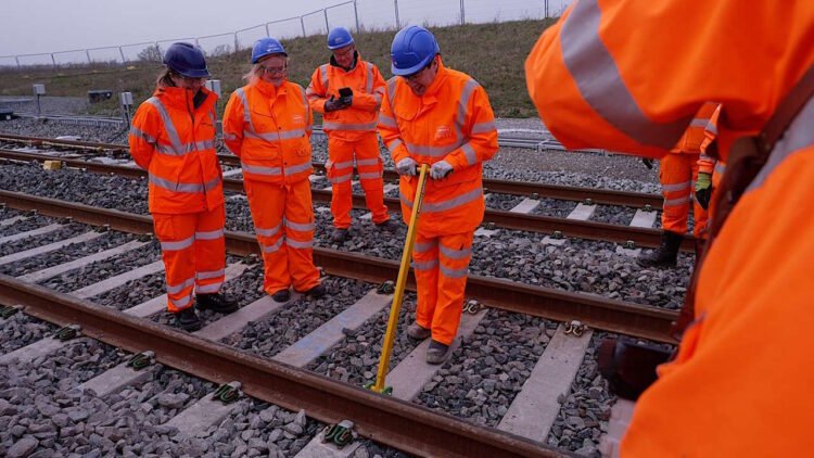 Minister clipping up the last section of rail. // Credit: Network Rail
