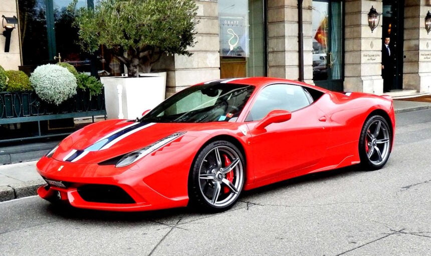 Switzerland, Geneva - red Ferrari parked outside the Four Seasons Hotel des Bergues. // Credit: Roger Smith