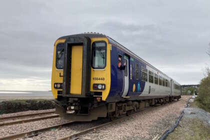 A Northern train travelling through Grange-over-Sands