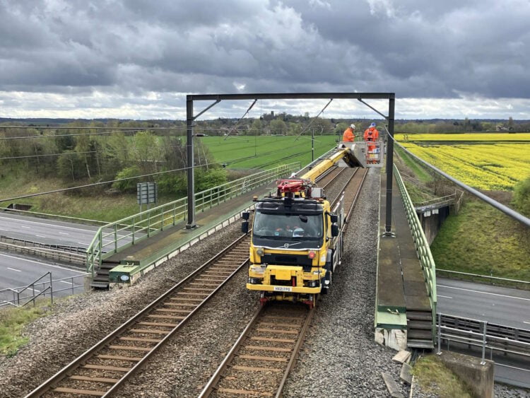 Network Rail engineers maintaining the cables on the railway bridge over the M6 Toll