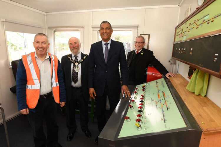 Lord Syed Kamal visited Medstead and Four Marks station to view and open the new signal box, created and installed by volunteers on the Watercress line as they update the technology from pullies and leavers to electronically controlled points and signals.
 Pictured: Lord Syed Kamall officially opens the new signal box before being taken through how it works..©Russell Sach/Watercress Line