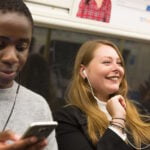 Customers using mobile phones on Tube train. // Credit: Transport for London