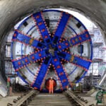 Construction worker posing in front of the Tunnel Boring Machine. // Credit: HS2