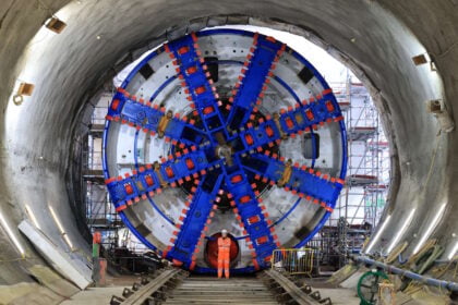 Construction worker posing in front of the Tunnel Boring Machine. // Credit: HS2