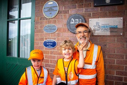 Adam, Ollie & Ian Evans next to the newly unveiled award plaque. // Credit: Talyllyn Railway